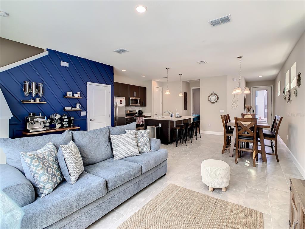 208 Villa Domani Circle Davenport, FL 33896 - Photo 8 of 26 a living room with furniture and kitchen view