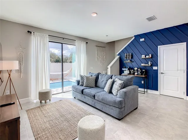 a living room with furniture and a flat screen tv