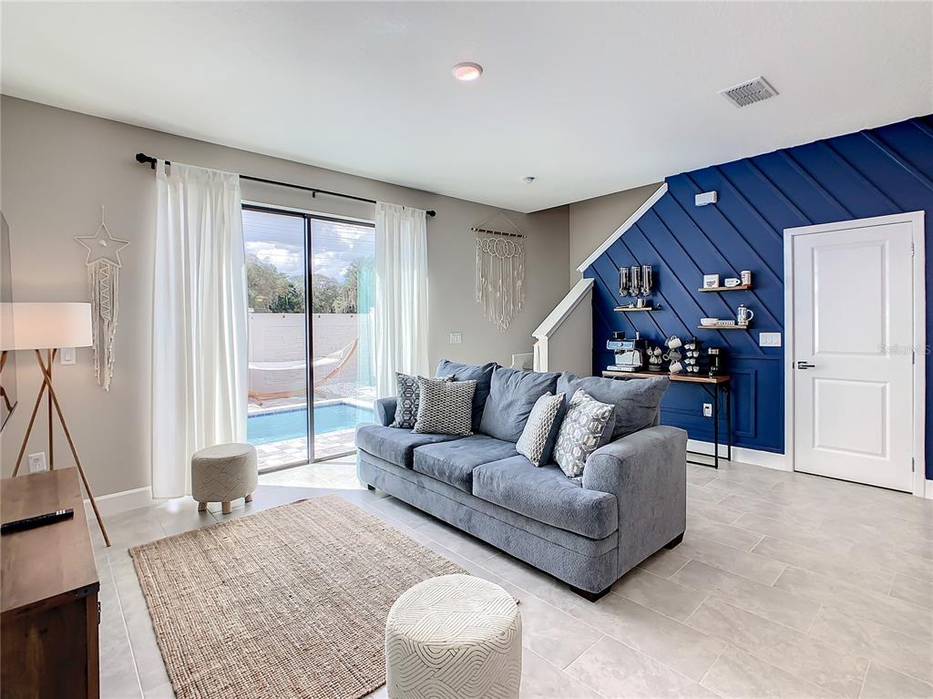 208 Villa Domani Circle Davenport, FL 33896 - Photo 9 of 26 a living room with furniture and a flat screen tv