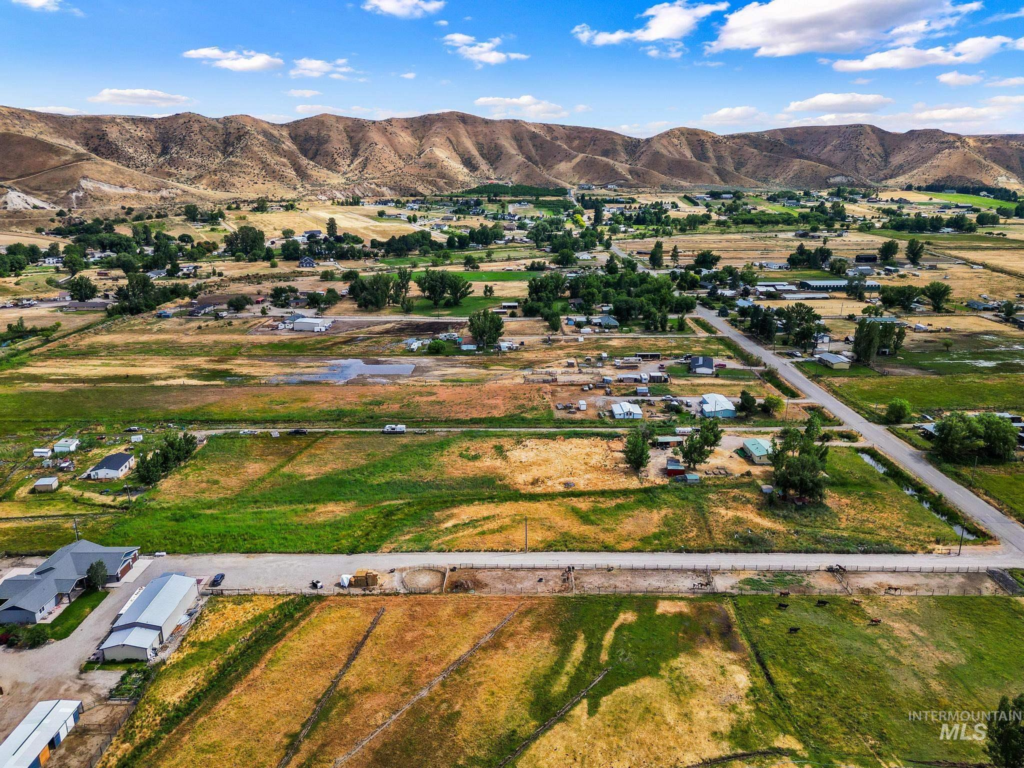 3680 South Mill Road Emmett, ID 83617 - Photo 38 of 38 Expansive rural landscape with distant mountains under a blue sky