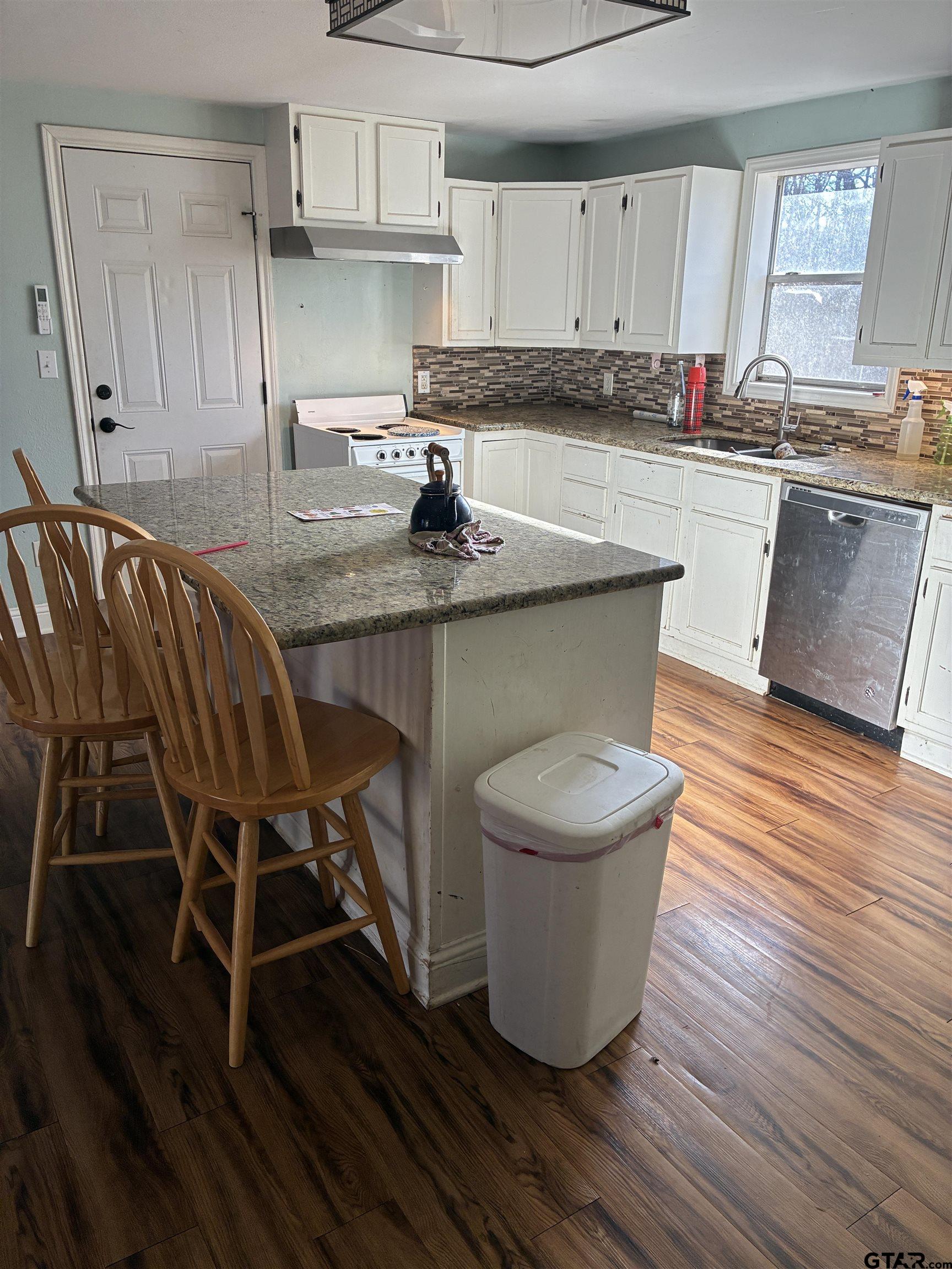 20519 Highway 69 Rusk, TX 75785 - Photo 14 of 20 a kitchen with stainless steel appliances granite countertop a table chairs sink and cabinets