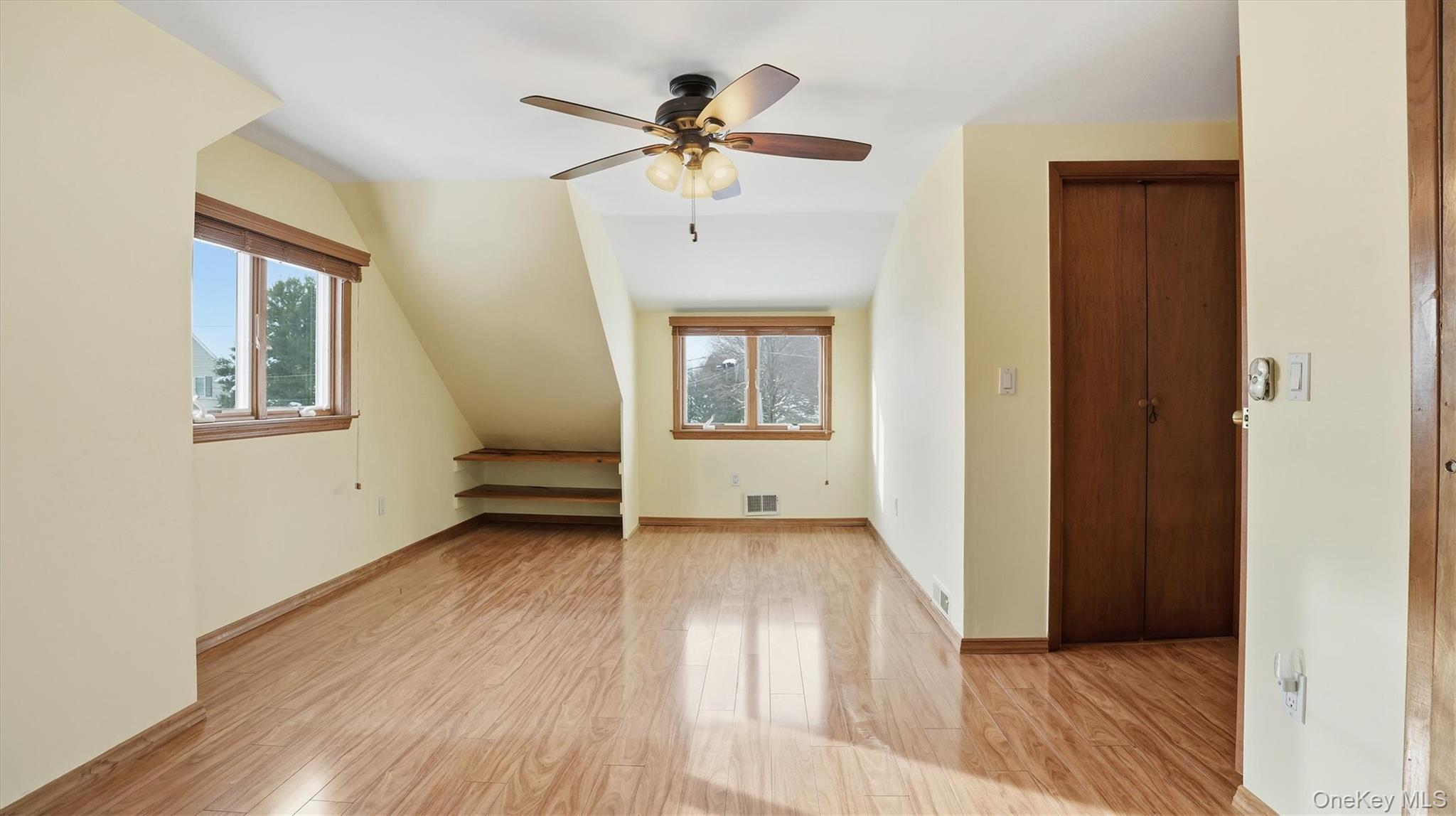 47 Vincent Road Hicksville, NY 11801 - Photo 13 of 21 a view of an empty room with a window and wooden floor