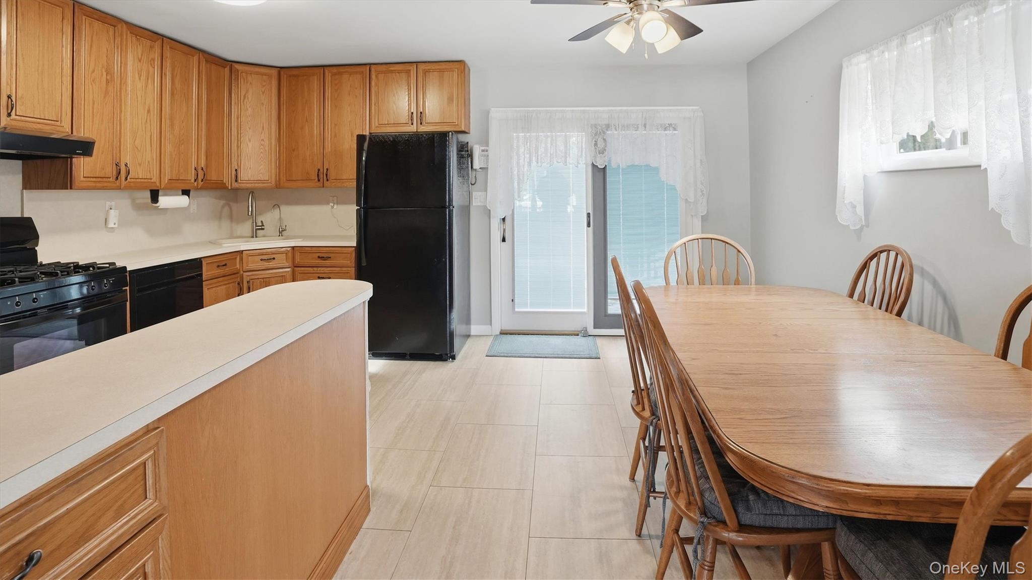 47 Vincent Road Hicksville, NY 11801 - Photo 6 of 21 a kitchen with a table chairs refrigerator and a sink