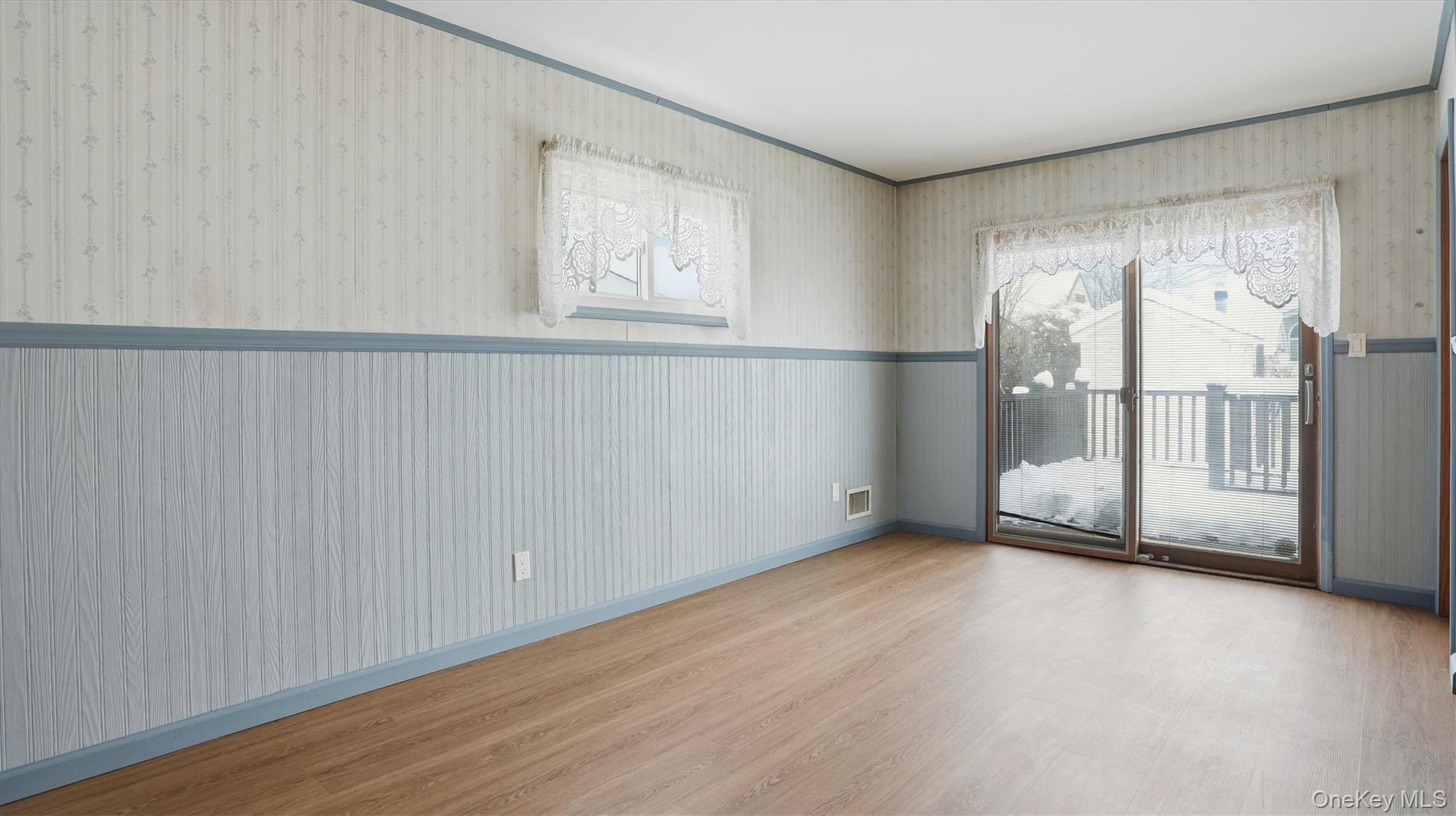 47 Vincent Road Hicksville, NY 11801 - Photo 8 of 21 an empty room with wooden floor and windows