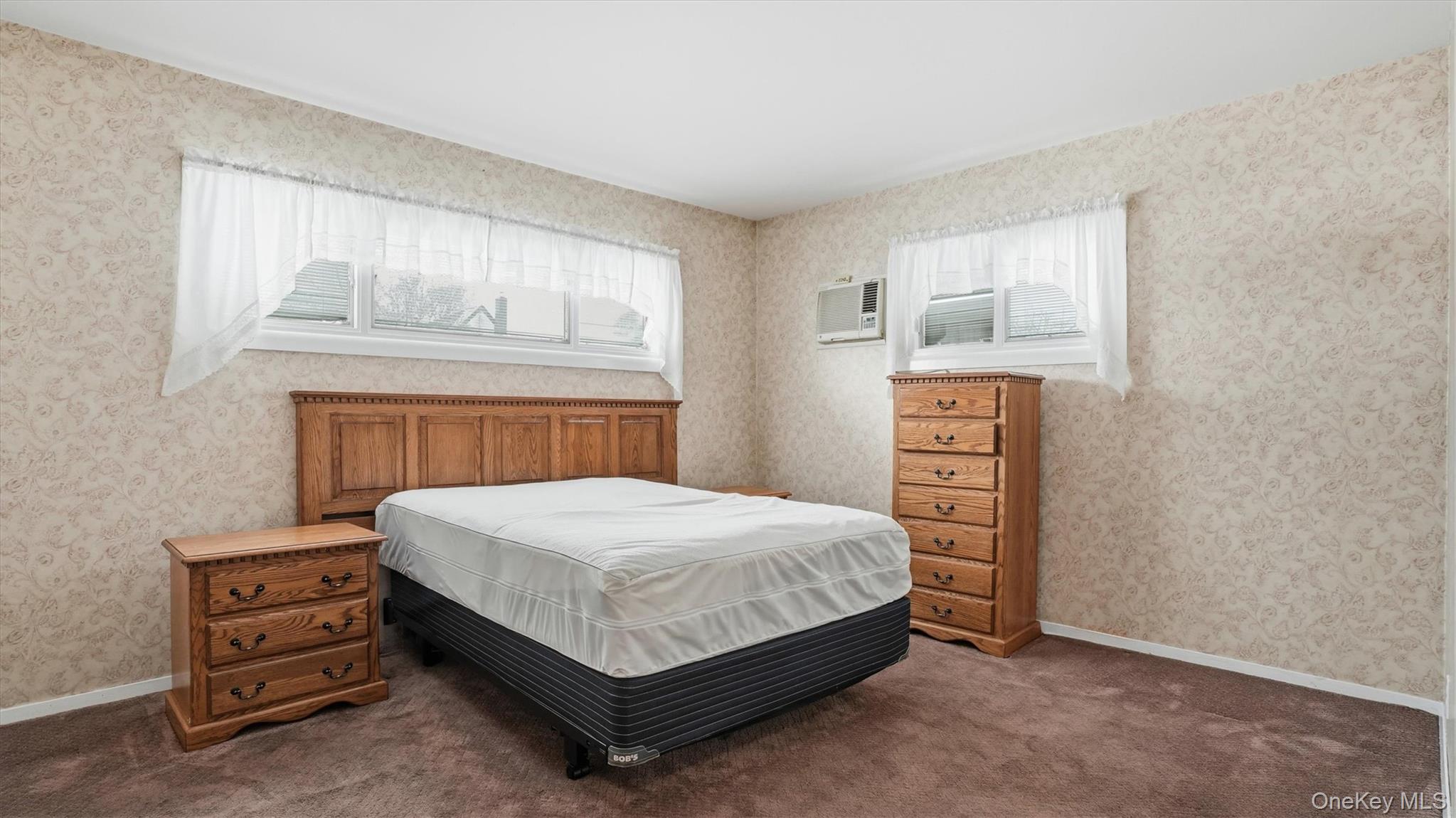 47 Vincent Road Hicksville, NY 11801 - Photo 10 of 21 a bedroom with a bed a dresser and painting