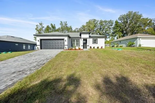 a front view of a house with a yard and garage