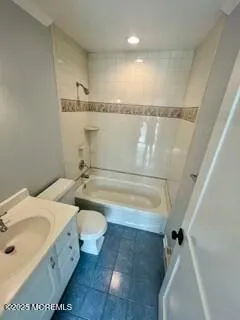 a bathroom with a sink mirror vanity and toilet