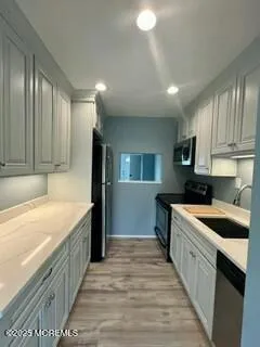 a kitchen with a sink stove and refrigerator