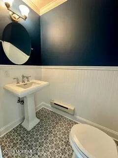a bathroom with a sink a toilet and mirror