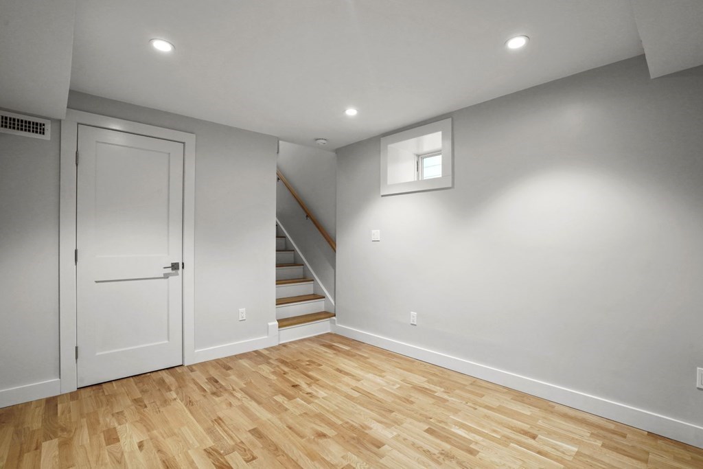 14 Hardwick Street, Unit 1 Cambridge, MA 02141 - Photo 16 of 31 an empty room with wooden floor and white walls