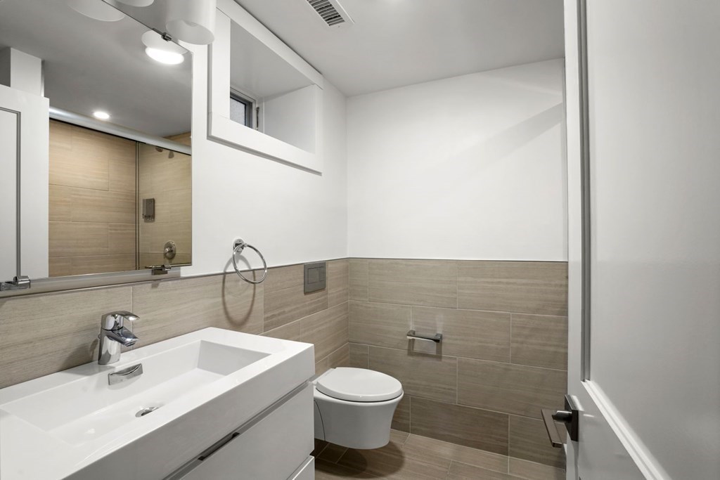14 Hardwick Street, Unit 1 Cambridge, MA 02141 - Photo 21 of 31 a bathroom with a toilet sink and mirror
