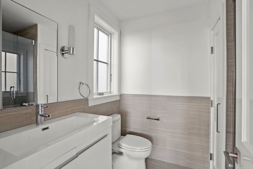 14 Hardwick Street, Unit 1 Cambridge, MA 02141 - Photo 24 of 31 a bathroom with a sink a toilet and a mirror