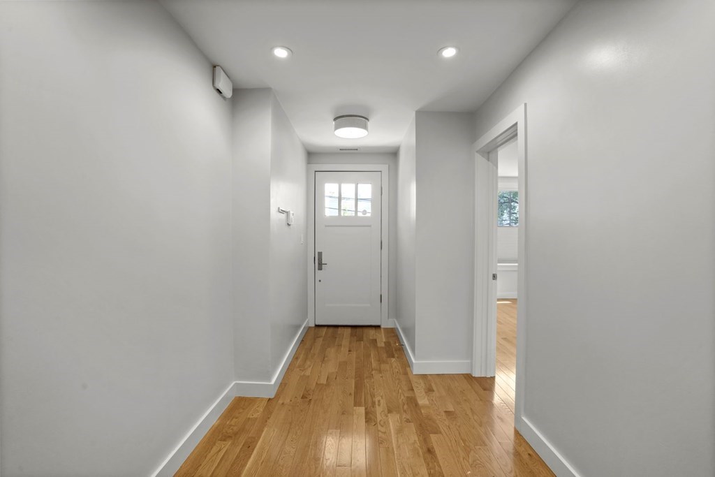 14 Hardwick Street, Unit 1 Cambridge, MA 02141 - Photo 3 of 31 a view of a hallway with wooden floor and a bathroom