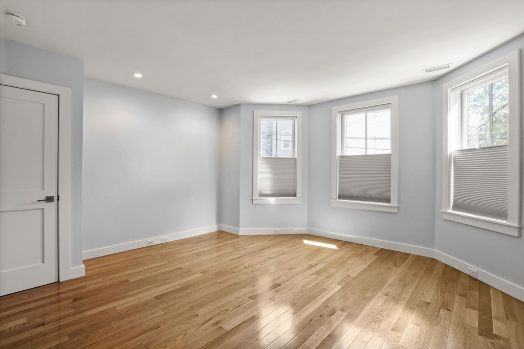 14 Hardwick Street, Unit 1 Cambridge, MA 02141 - Photo 5 of 31 a view of empty room with wooden floor and fan