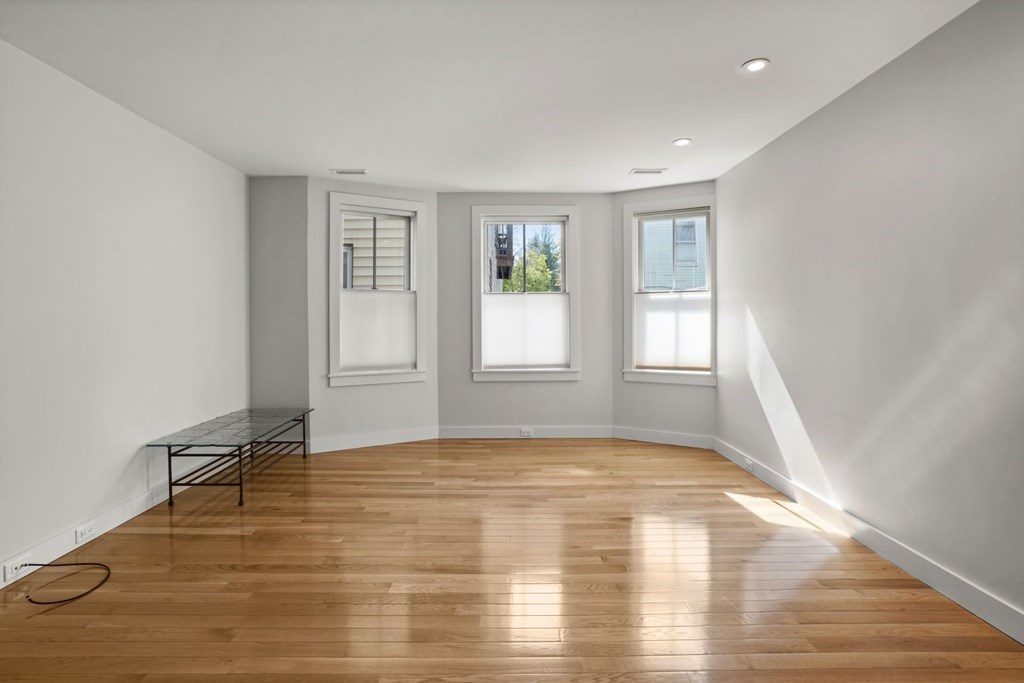 14 Hardwick Street, Unit 1 Cambridge, MA 02141 - Photo 7 of 31 a view of an empty room with glass door and wooden floor