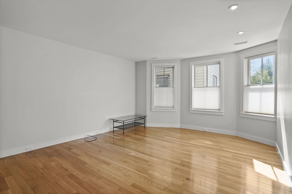 14 Hardwick Street, Unit 1 Cambridge, MA 02141 - Photo 8 of 31 an empty room with wooden floor and windows
