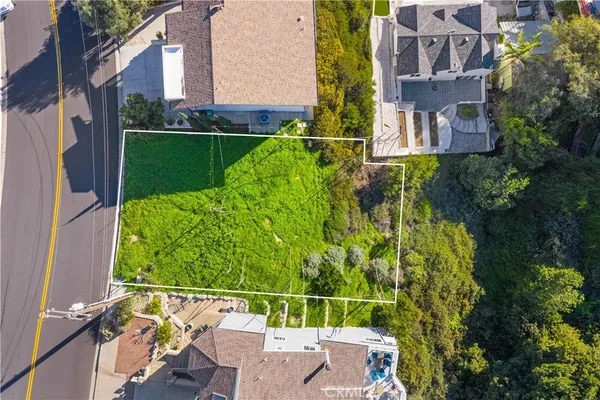 an aerial view of a house with a yard basket ball court and outdoor seating