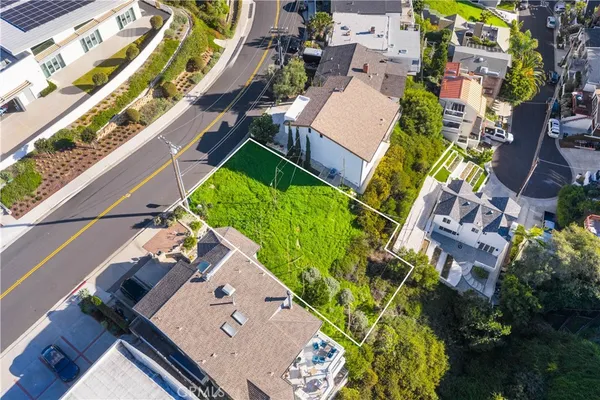 an aerial view of a house with a garden and trees