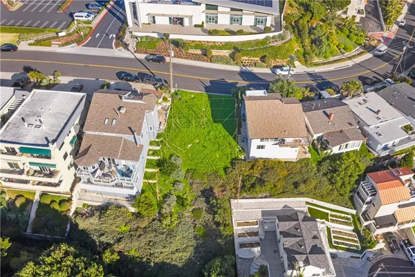 an aerial view of a residential apartment building with a yard