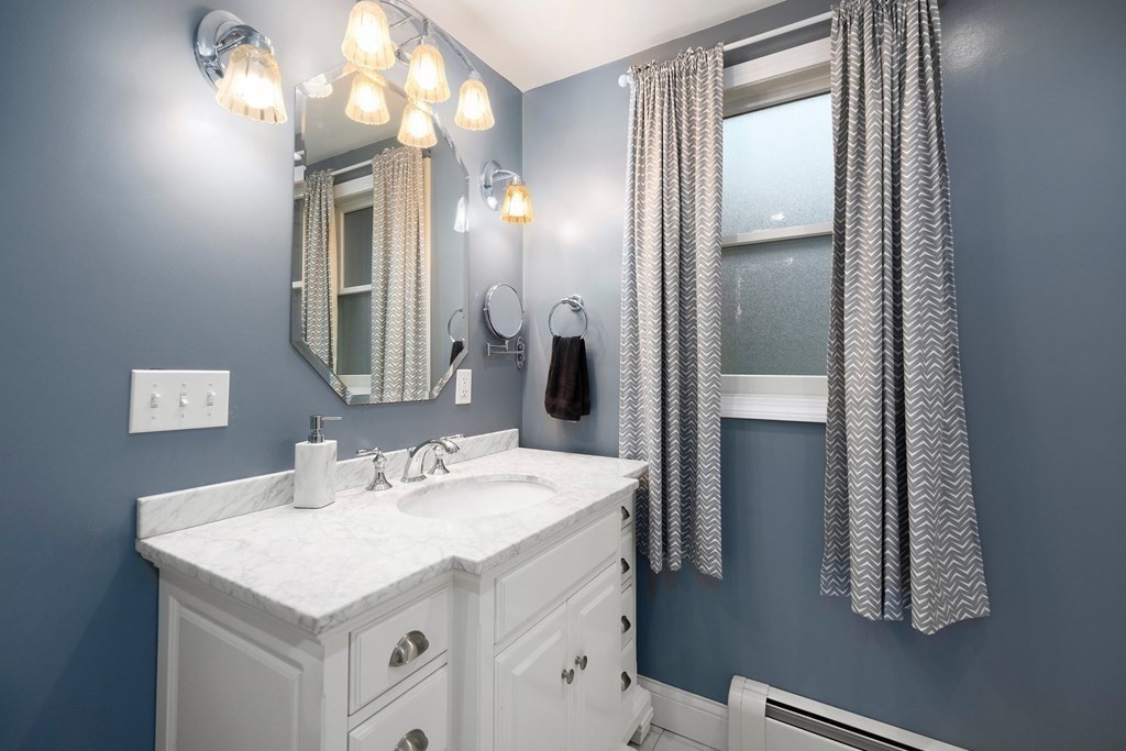 102 Orange Street Reading, MA 01867 - Photo 13 of 23 a bathroom with a sink vanity and a mirror