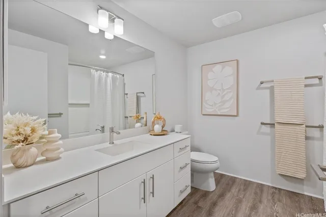 a bathroom with a double vanity sink toilet and a mirror