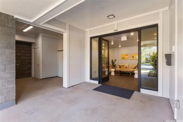 a view of a livingroom with furniture and floor to ceiling window