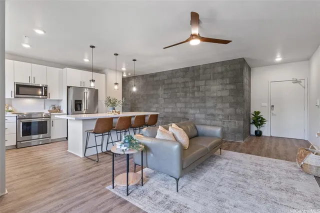 a living room with furniture and kitchen view