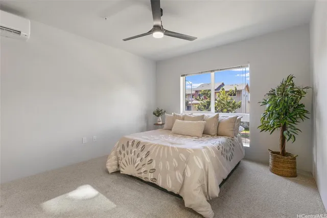 a bedroom with a bed and a potted plant
