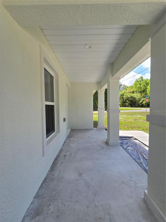 131 Fisher Road Ocklawaha, FL 32179 - Photo 13 of 42 a view of an empty room with a fireplace and a window