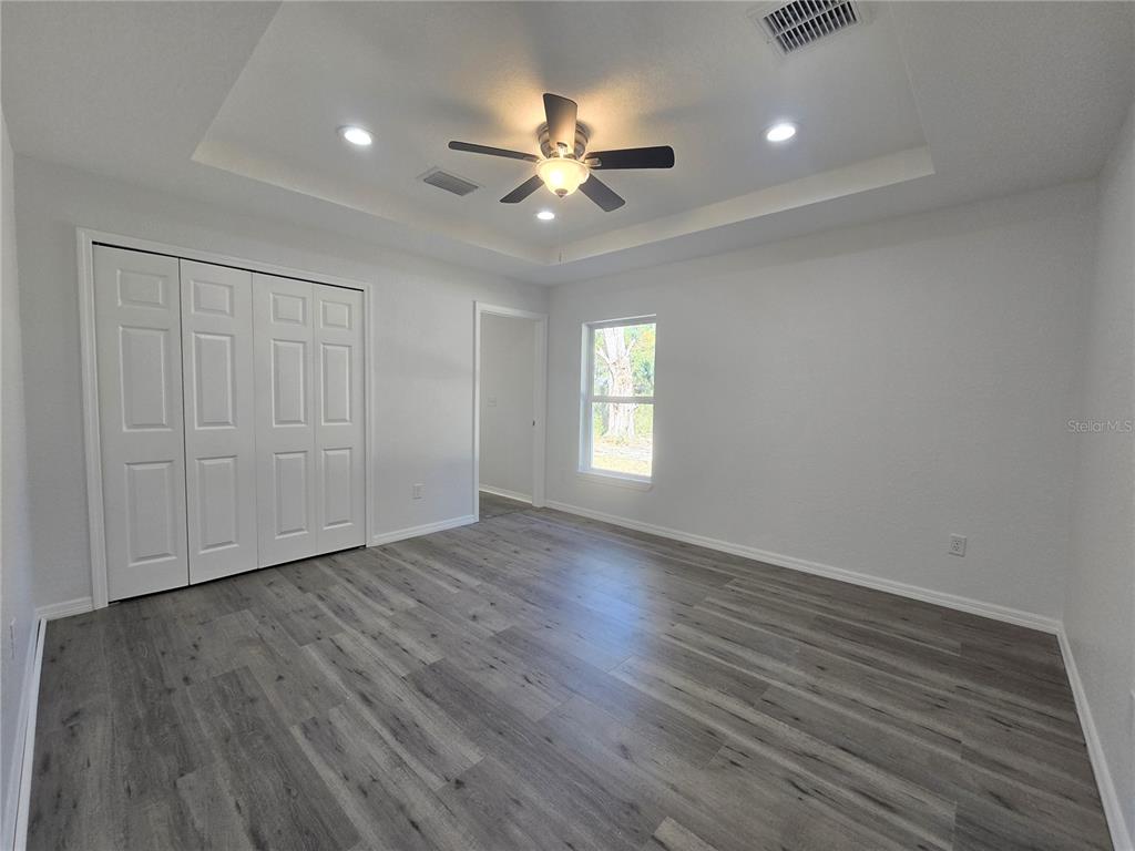 131 Fisher Road Ocklawaha, FL 32179 - Photo 19 of 41 wooden floor in an empty room with a window