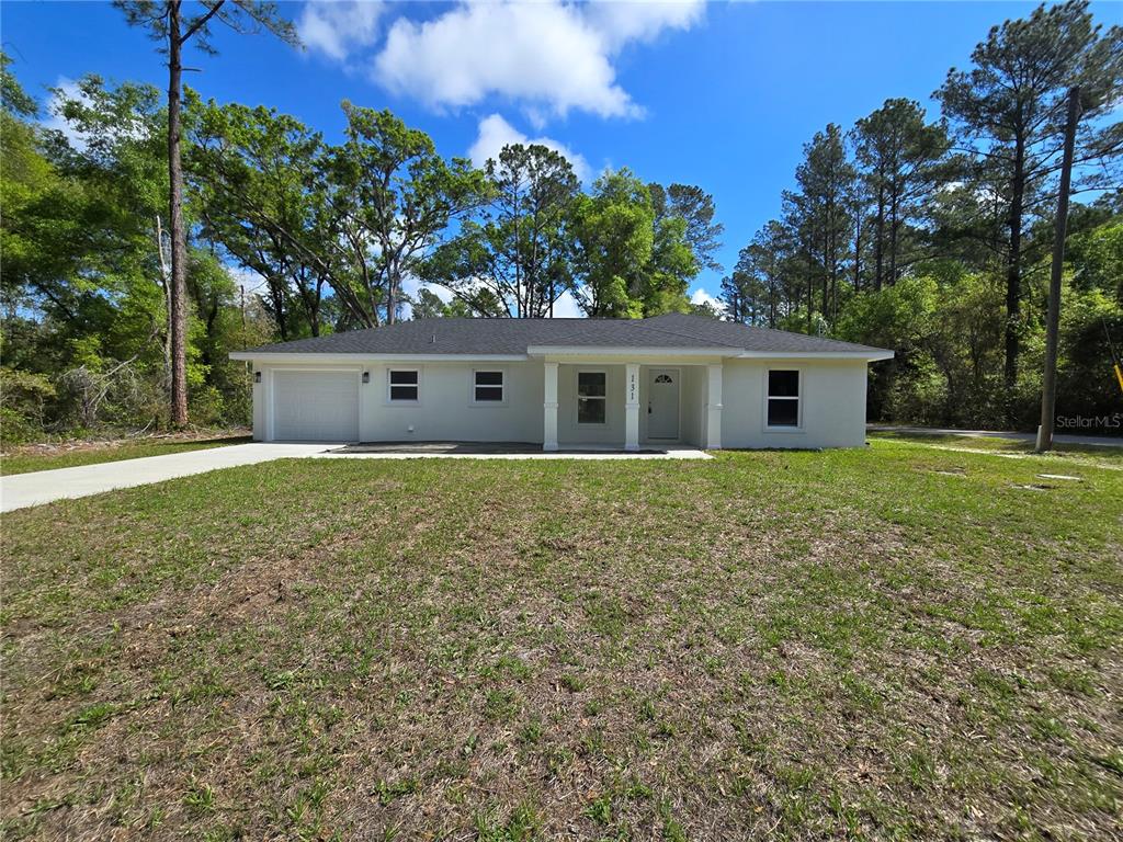 131 Fisher Road Ocklawaha, FL 32179 - Photo 2 of 42 a front view of a house with garden
