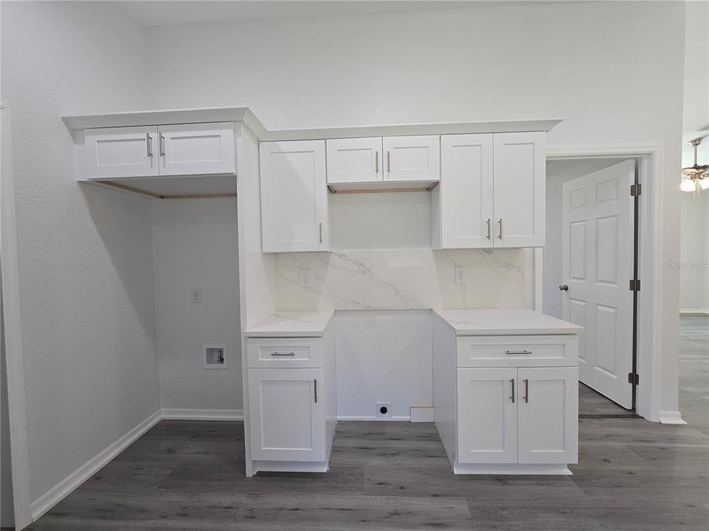 131 Fisher Road Ocklawaha, FL 32179 - Photo 22 of 42 a view of cabinets a sink and dishwasher in a white cabinet
