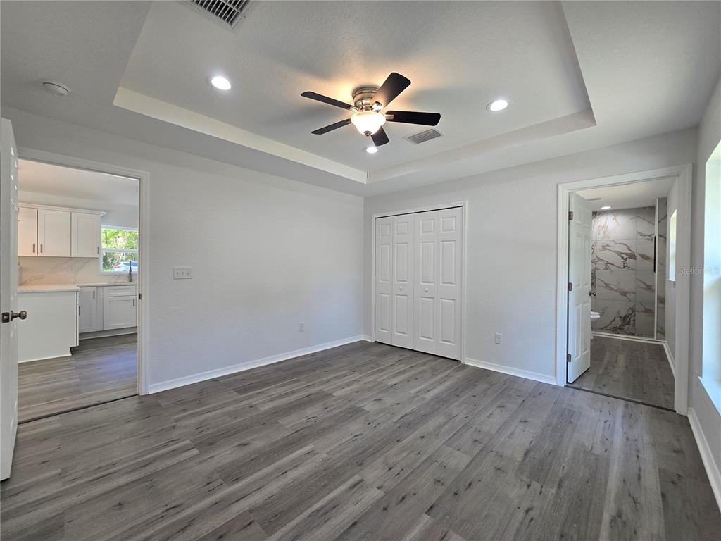 131 Fisher Road Ocklawaha, FL 32179 - Photo 24 of 42 wooden floor in an empty room with a window