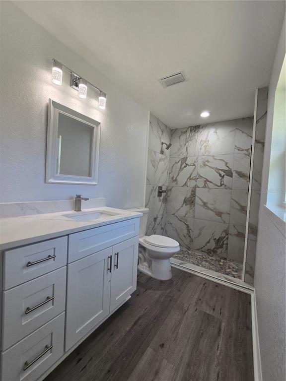 131 Fisher Road Ocklawaha, FL 32179 - Photo 25 of 42 a bathroom with a double vanity sink toilet and shower