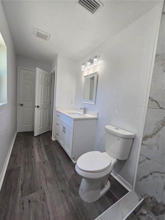 131 Fisher Road Ocklawaha, FL 32179 - Photo 26 of 42 a bathroom with a toilet sink and a mirror