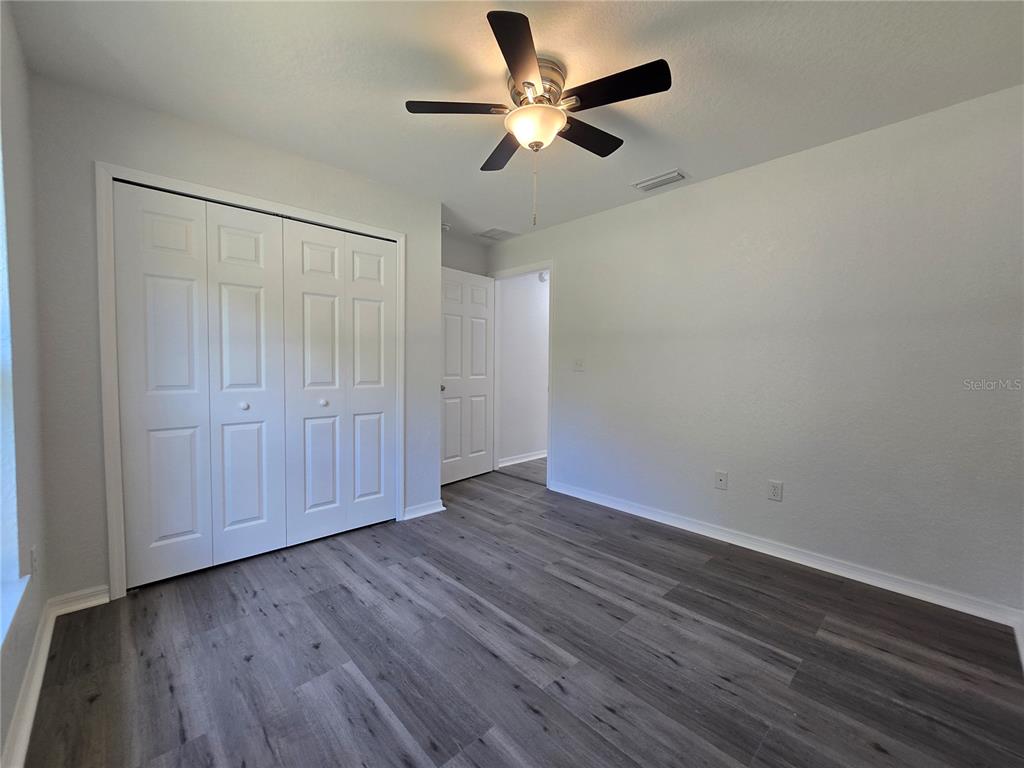 131 Fisher Road Ocklawaha, FL 32179 - Photo 32 of 42 a view of an empty room with wooden floor