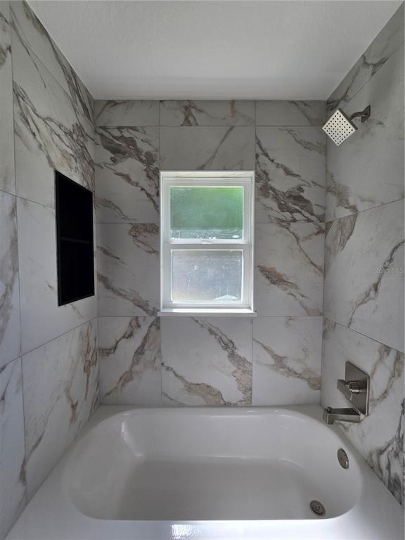 131 Fisher Road Ocklawaha, FL 32179 - Photo 34 of 42 a bathroom with a bathtub and a shower