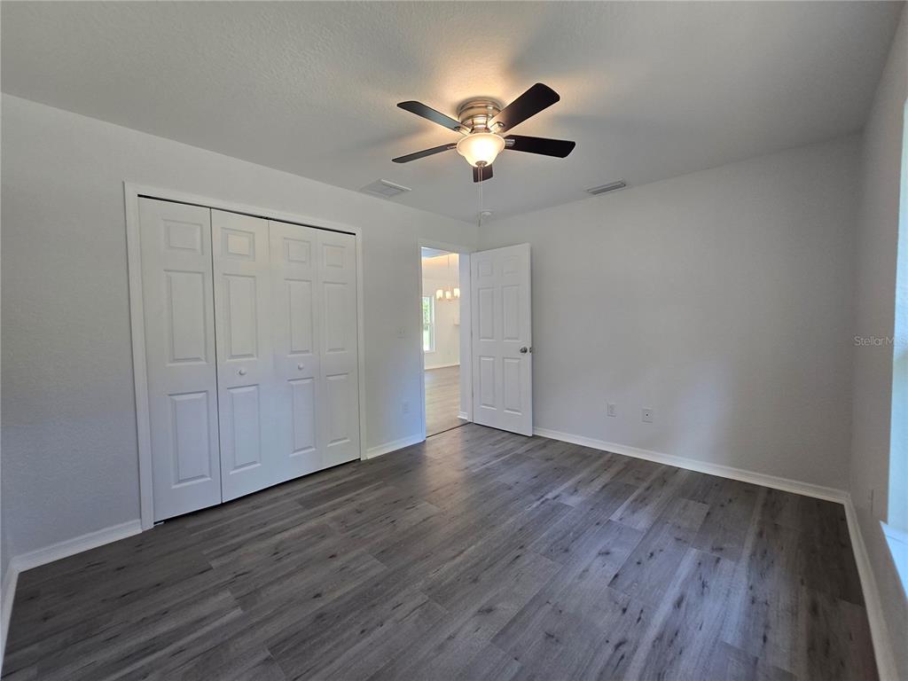 131 Fisher Road Ocklawaha, FL 32179 - Photo 36 of 42 a view of an empty room with wooden floor