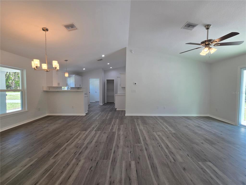 131 Fisher Road Ocklawaha, FL 32179 - Photo 37 of 42 a view of a room with wooden floor and a ceiling fan