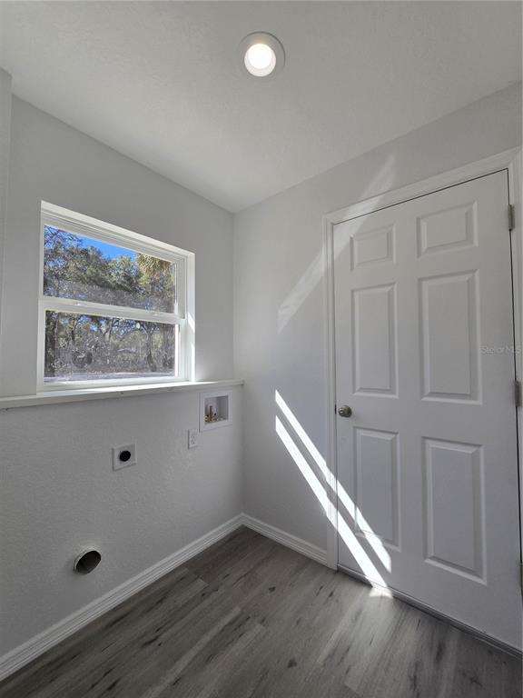 131 Fisher Road Ocklawaha, FL 32179 - Photo 37 of 41 an empty room with wooden floor and windows