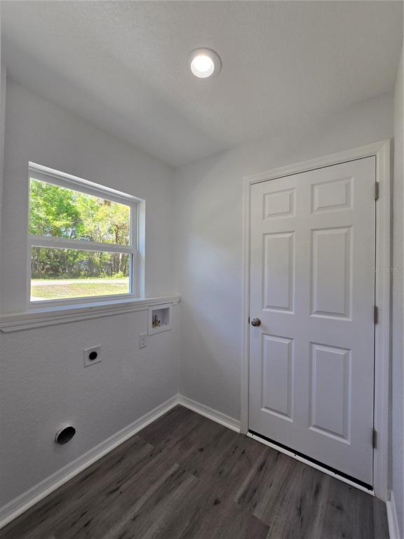 131 Fisher Road Ocklawaha, FL 32179 - Photo 39 of 42 an empty room with wooden floor and windows