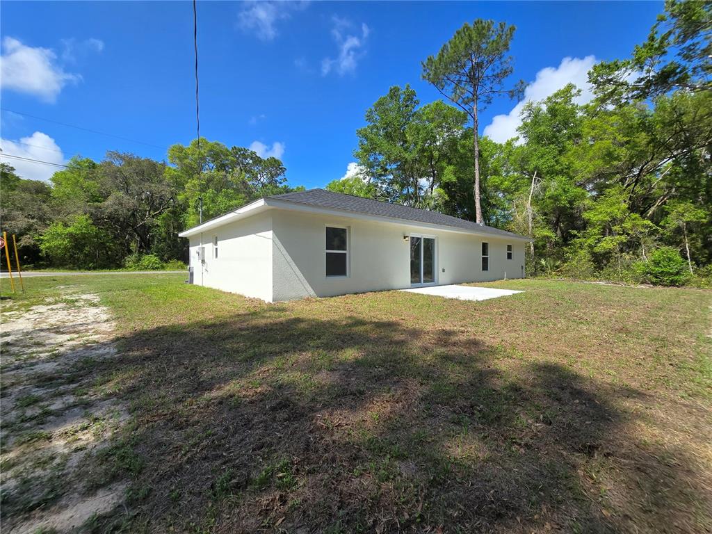 131 Fisher Road Ocklawaha, FL 32179 - Photo 5 of 42 a view of a house with backyard and garden