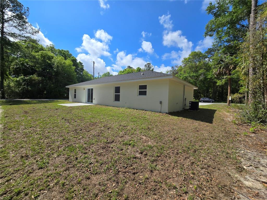 131 Fisher Road Ocklawaha, FL 32179 - Photo 6 of 42 a view of a house with a backyard