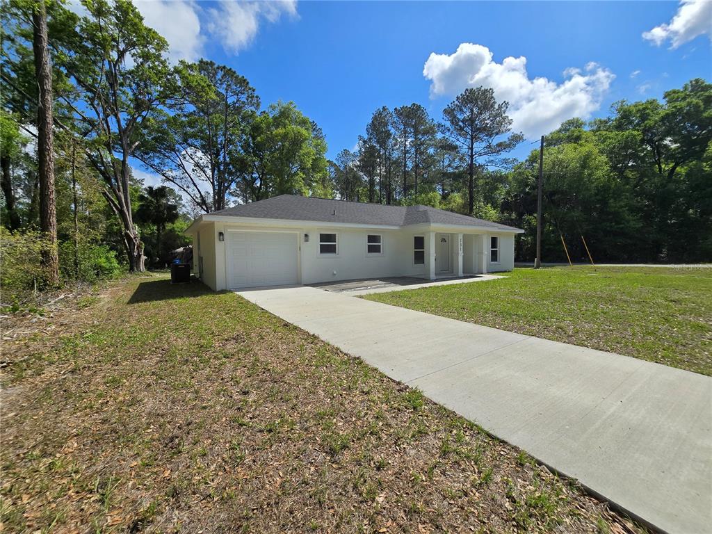 131 Fisher Road Ocklawaha, FL 32179 - Photo 7 of 42 a view of a house with a yard and a garden