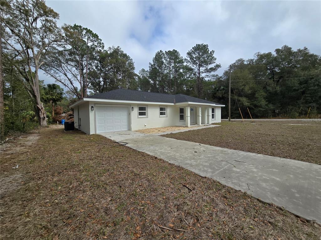 131 Fisher Road Ocklawaha, FL 32179 - Photo 8 of 41 a house with trees in the background