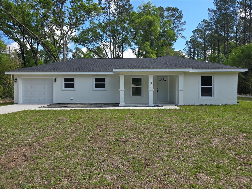 131 Fisher Road Ocklawaha, FL 32179 - Photo 9 of 42 a house with trees in the background