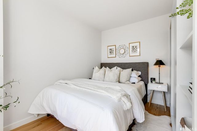 a large bed sitting in a bedroom next to a bathroom