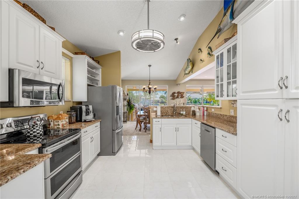 5854 Southeast Horseshoe Point Road Stuart, FL 34997 - Photo 20 of 56 a kitchen with stainless steel appliances granite countertop a stove and cabinets