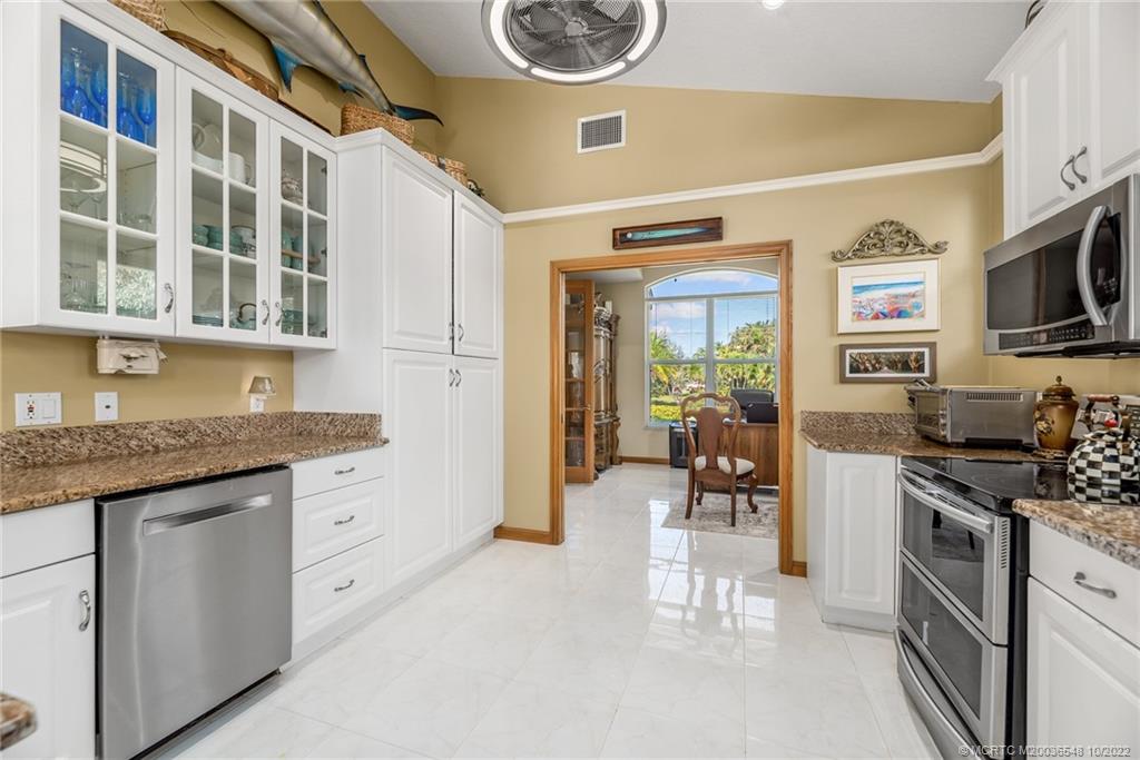 5854 Southeast Horseshoe Point Road Stuart, FL 34997 - Photo 24 of 56 a kitchen with stainless steel appliances granite countertop a stove and a sink
