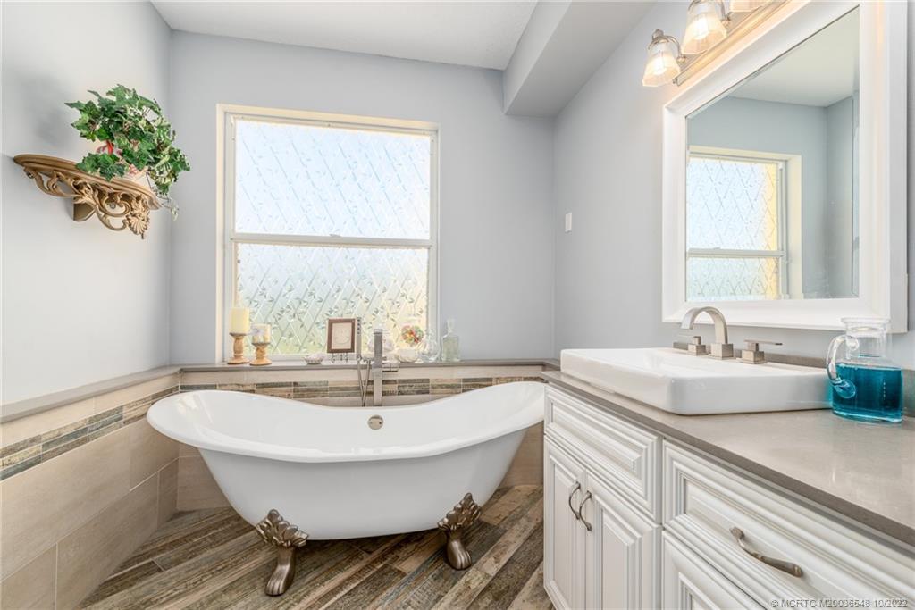 5854 Southeast Horseshoe Point Road Stuart, FL 34997 - Photo 29 of 56 a bathroom with a sink and a mirror